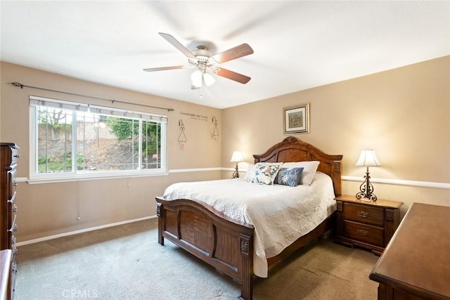 carpeted bedroom with a ceiling fan and baseboards