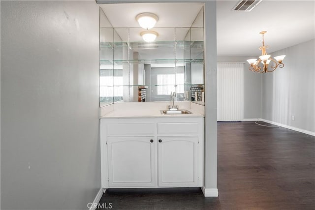 bathroom with visible vents, baseboards, an inviting chandelier, and wood finished floors