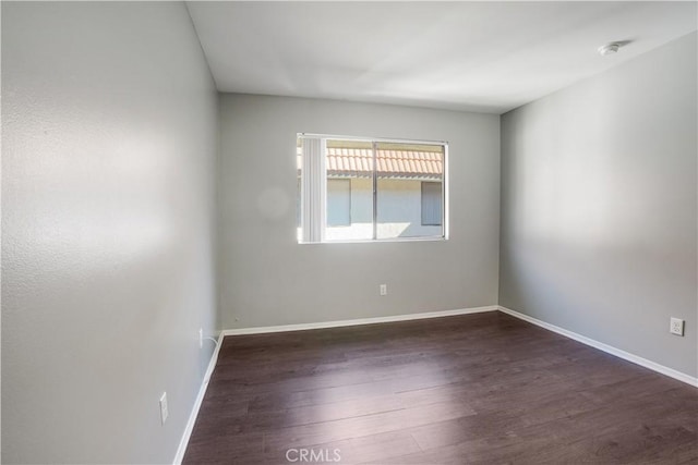 empty room with wood finished floors and baseboards