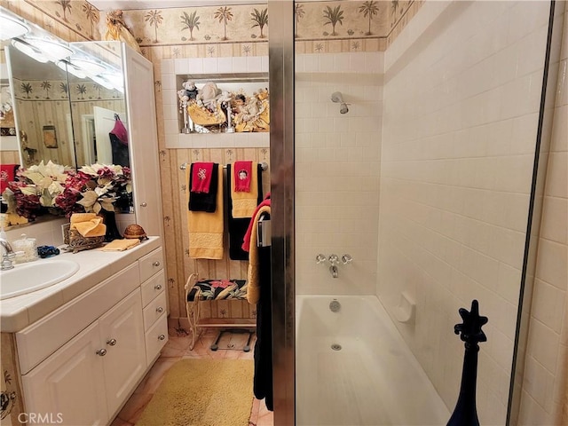 bathroom featuring shower / bath combination, vanity, and wallpapered walls