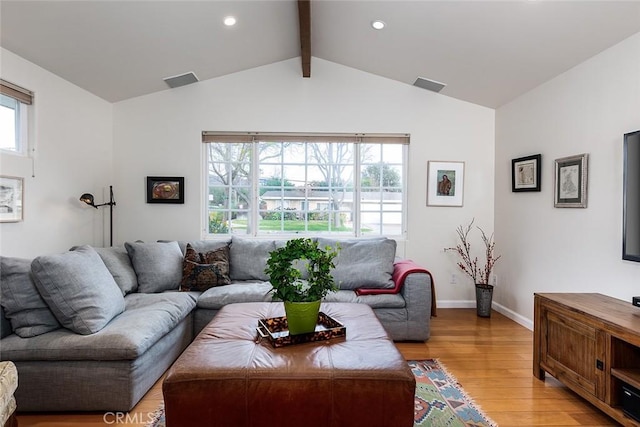 living area featuring lofted ceiling with beams, light wood-type flooring, visible vents, and baseboards