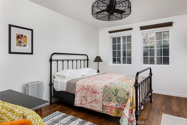 bedroom featuring baseboards and hardwood / wood-style flooring