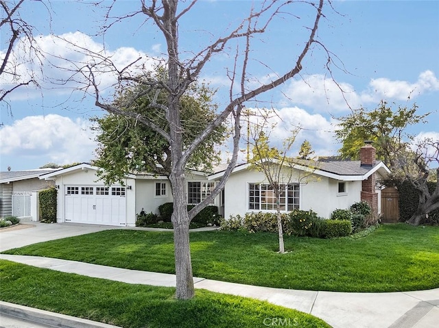 single story home with an attached garage, fence, a front lawn, and concrete driveway