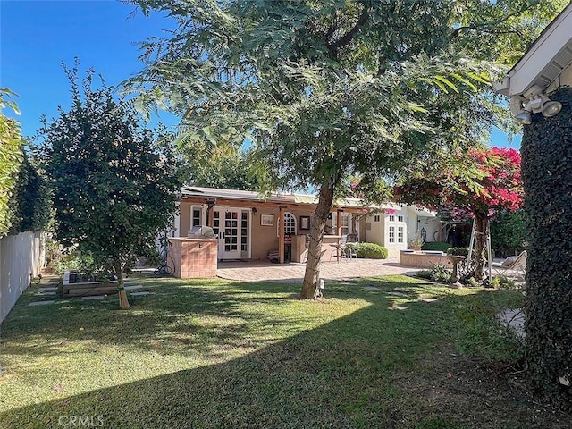 view of yard featuring french doors, a patio area, and fence