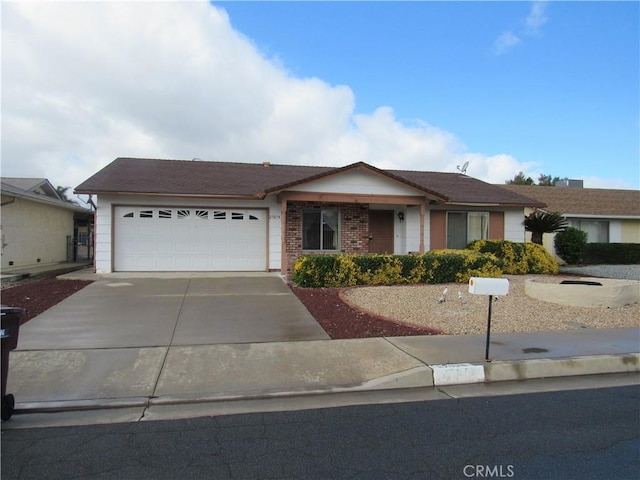 single story home with an attached garage, driveway, and brick siding