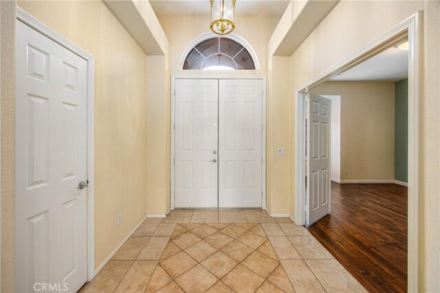 foyer entrance featuring light tile patterned floors and baseboards