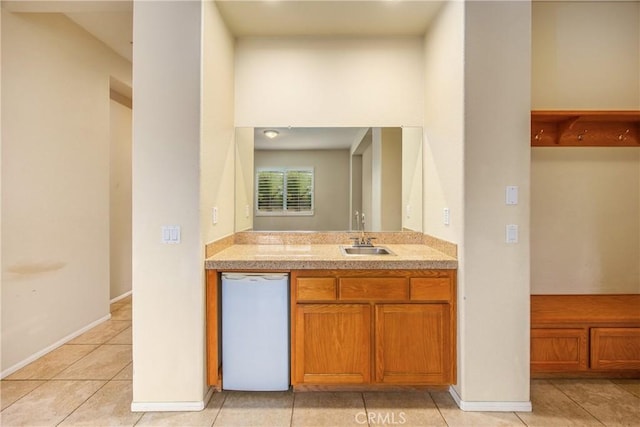 bathroom with vanity, baseboards, and tile patterned floors