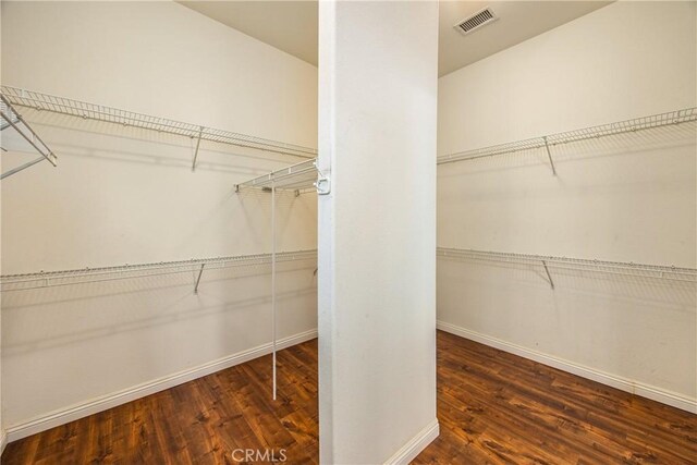 walk in closet featuring wood finished floors and visible vents