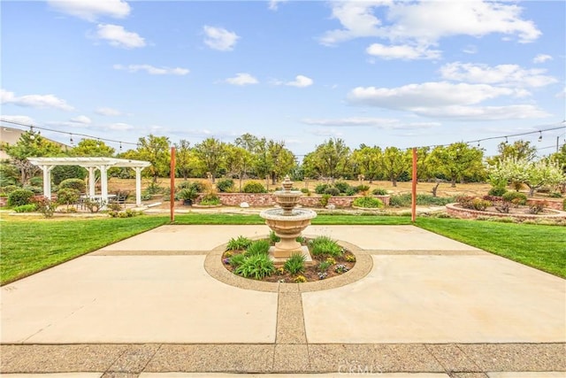 view of community featuring a yard, a patio area, and a pergola