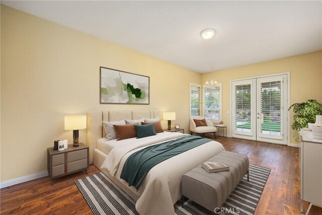 bedroom featuring dark wood-style floors, baseboards, and access to exterior