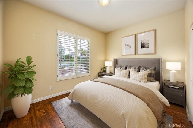 bedroom with wood finished floors and baseboards