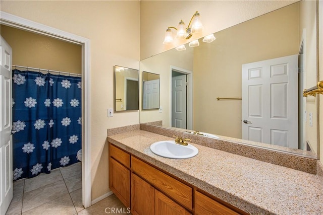 bathroom with toilet, vanity, and tile patterned floors