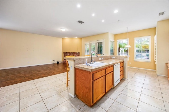 kitchen with visible vents, dishwasher, a sink, and light tile patterned floors