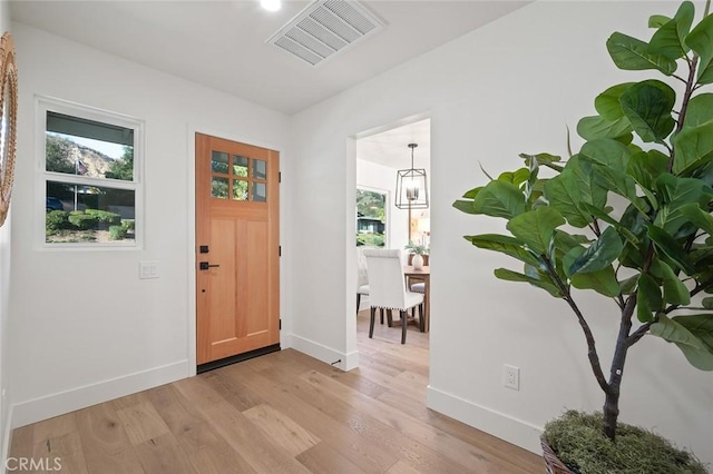 entryway featuring baseboards, light wood-style flooring, and healthy amount of natural light
