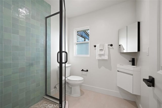 full bathroom featuring a stall shower, vanity, toilet, and baseboards
