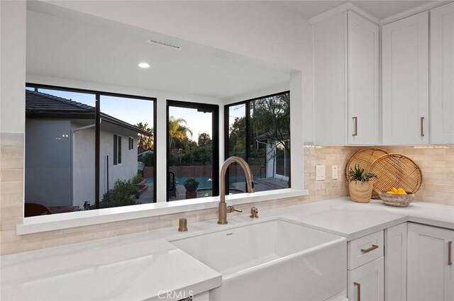 1985 Highland Oaks Dr, Arcadia, CA 91006 - kitchen with white cabinetry, decorative backsplash, and light countertops