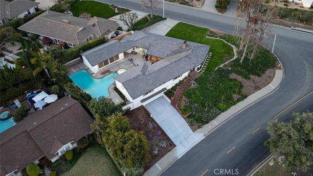 aerial view of property and surrounding area featuring a pool area