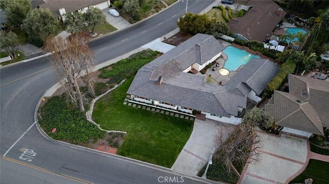 aerial view of property and surrounding area with a pool area