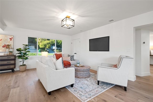 living room featuring wood finished floors and baseboards