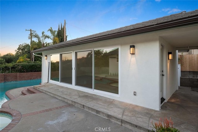 back of property featuring a patio area and stucco siding