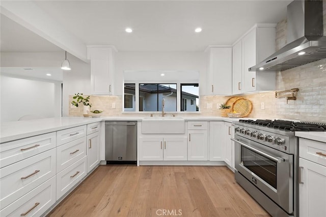 1985 Highland Oaks Dr, Arcadia, CA 91006 - kitchen featuring wall chimney range hood, stainless steel appliances, white cabinetry, light countertops, and decorative backsplash