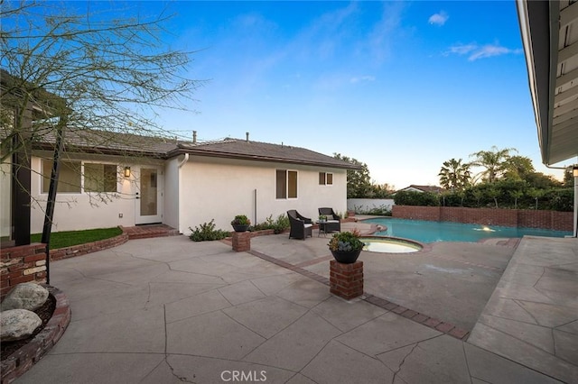 view of swimming pool with a patio and a pool with connected hot tub