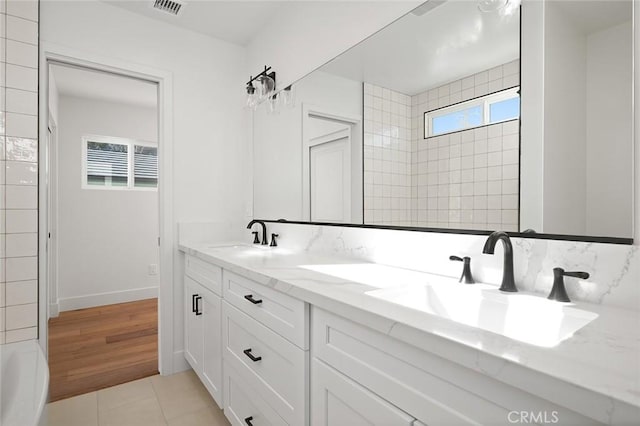full bathroom with double vanity and tile patterned flooring
