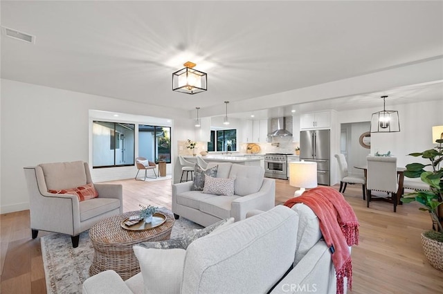 living room featuring light wood finished floors and baseboards