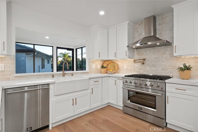 1985 Highland Oaks Dr, Arcadia, CA 91006 - kitchen featuring wall chimney range hood, stainless steel appliances, light countertops, white cabinets, and recessed lighting