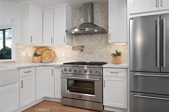 1985 Highland Oaks Dr, Arcadia, CA 91006 - kitchen featuring high quality appliances, wall chimney range hood, light countertops, and white cabinets