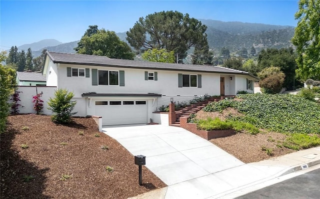 1985 Highland Oaks Dr, Arcadia, CA 91006 - view of front of house with a mountain view, driveway, stucco siding, and an attached garage