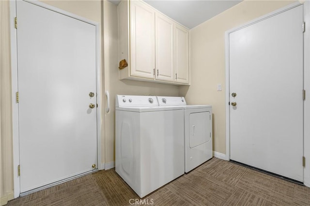 laundry room with washing machine and clothes dryer, cabinet space, and baseboards