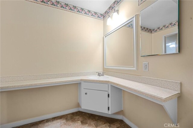 bathroom with baseboards and vanity