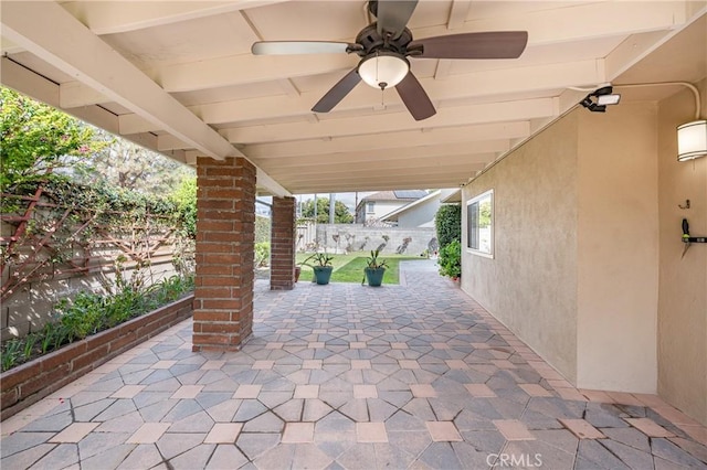 view of patio featuring fence and a ceiling fan