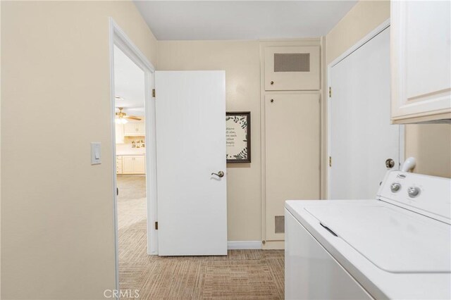 laundry room with visible vents, baseboards, a ceiling fan, cabinet space, and washer / dryer