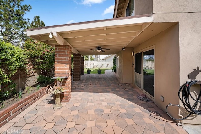 view of patio / terrace with ceiling fan and fence