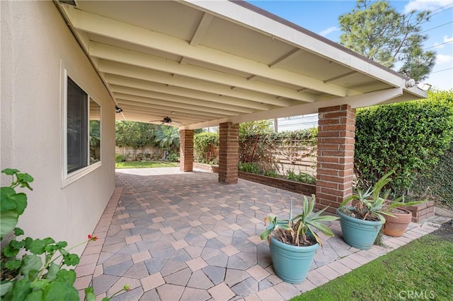 view of patio / terrace with ceiling fan and fence