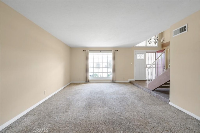 interior space with stairway, baseboards, visible vents, and carpet flooring