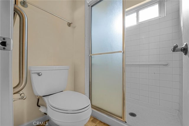 full bath featuring toilet and a stall shower