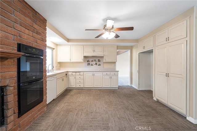 kitchen with dobule oven black, baseboards, light countertops, and dishwasher