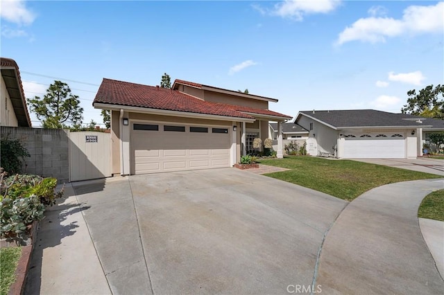 view of front of property featuring a garage, a tile roof, fence, a front lawn, and stucco siding