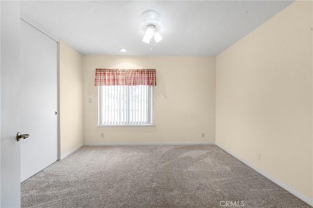 unfurnished room featuring carpet flooring and baseboards