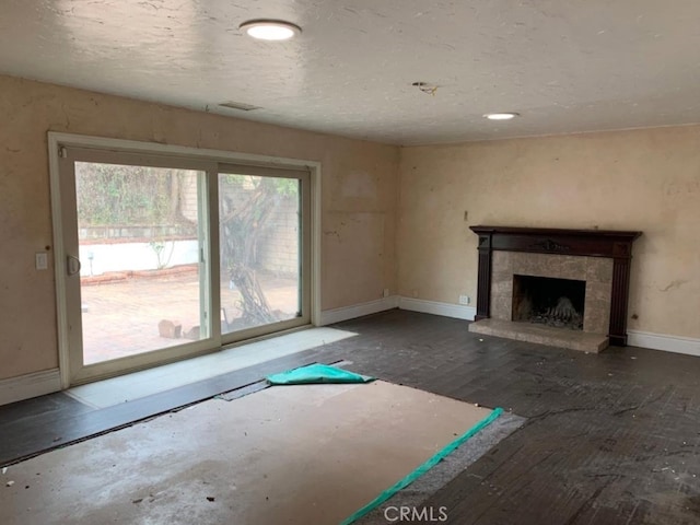 unfurnished living room featuring a fireplace and baseboards