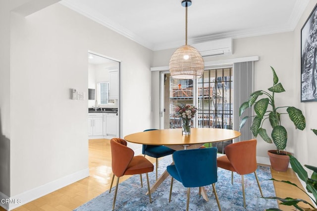 dining space featuring ornamental molding, an AC wall unit, plenty of natural light, and light wood finished floors