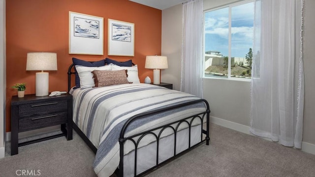 carpeted bedroom featuring baseboards