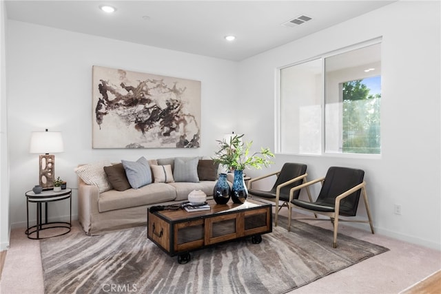 living area with carpet, visible vents, baseboards, and recessed lighting