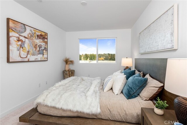 bedroom featuring carpet floors and baseboards