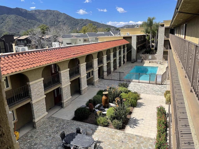 community pool featuring a patio area and a mountain view