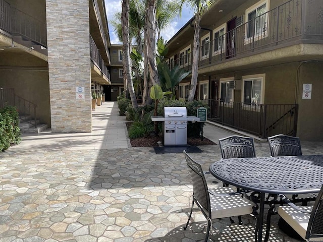 view of patio with outdoor dining area and a grill