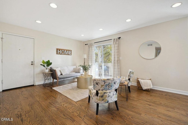 sitting room with baseboards, wood finished floors, and recessed lighting